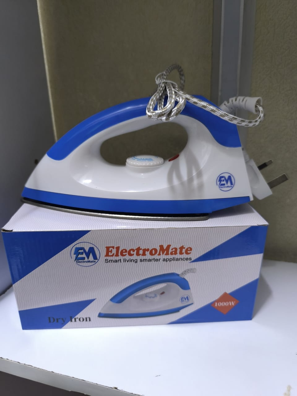 The ElectroMate Dry Iron is a practical and efficient home appliance designed to make ironing clothes quick and convenient. With its sleek white-and-blue design.